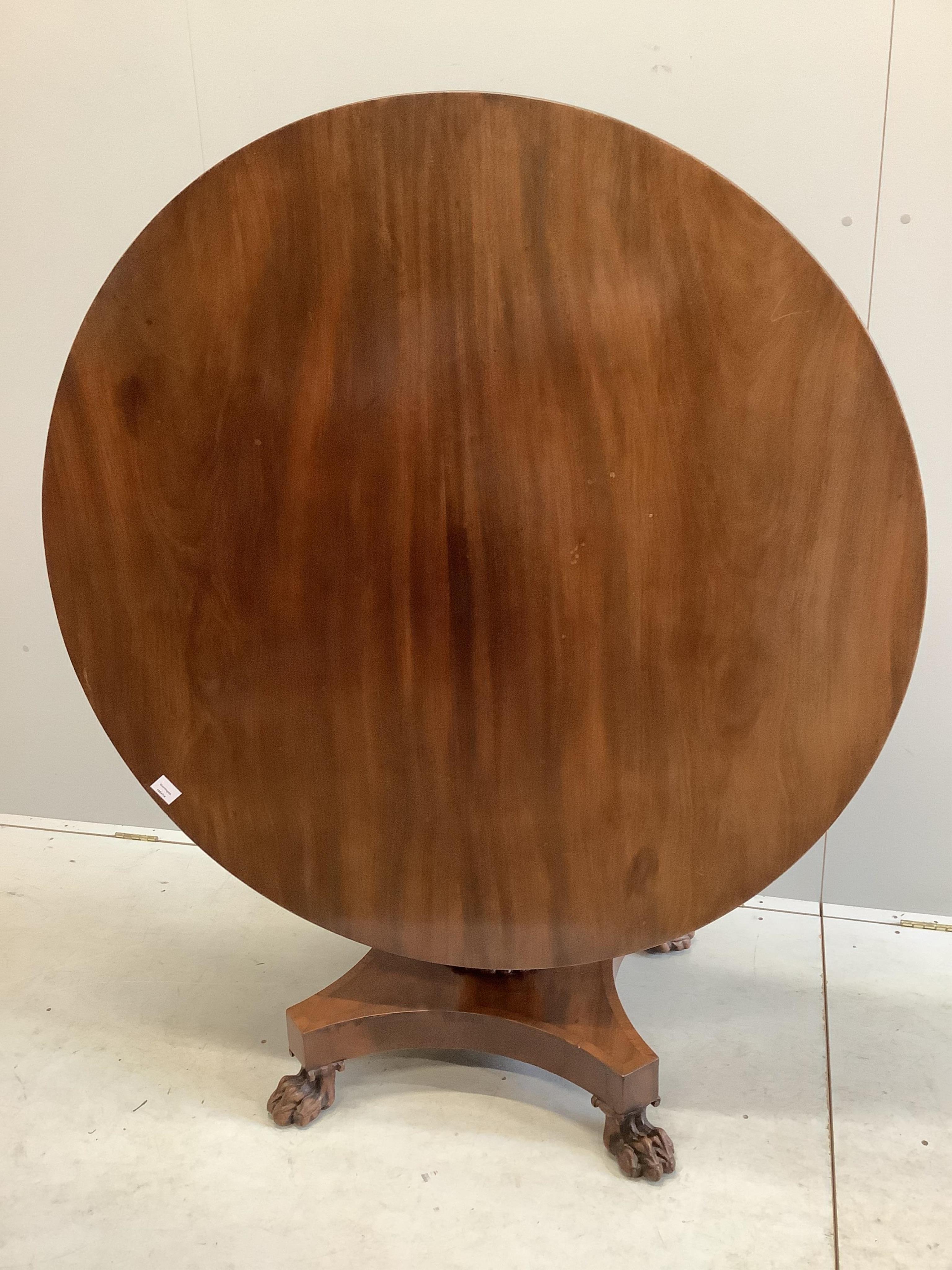 An early Victorian mahogany circular tilt top breakfast table, on a pillar and flat quadruple platform base, diameter 120cm, height 74cm. Condition - good